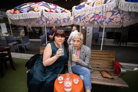 Jody Brodribb and Joanne Taylor celebrate the easing of restrictions in Yarraville on Friday afternoon.