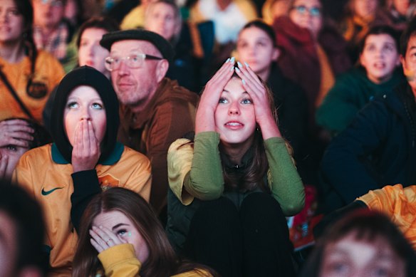 Fans react to the Matildas losing the match, at live site in Tumbalong Park, Darling Harbour.