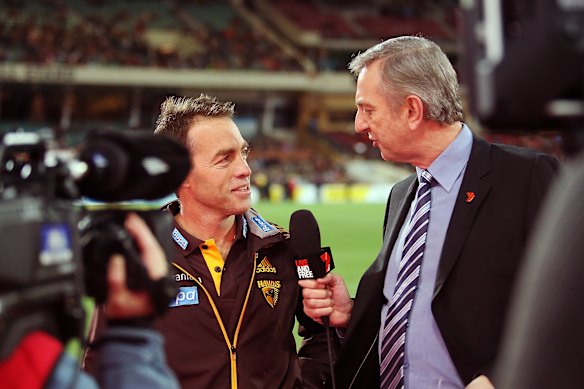 Alastair Clarkson of the Hawks is interviewed by Dennis Cometti in 2014. 