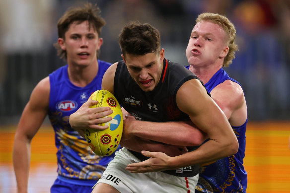 Reuben Ginbey of the Eagles tackles Archie Perkins of the Bombers. 