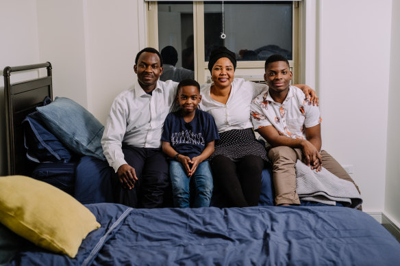 Tanitoluwa Adewumi, 8, his brother, Austin, and their parents, Kayode and Oluwatoyin, in the apartment they obtained after a GoFundMe drive raised more than $US200,000 on their behalf.