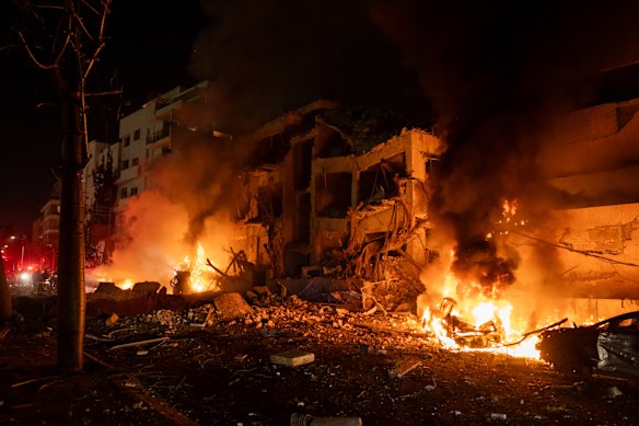 A fire burns after a missile strike hits central Tel Aviv.