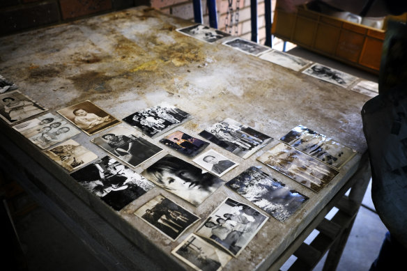Family photos are laid out to dry after being removed from drenched photo albums.