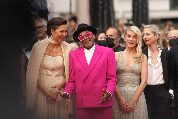 Jury president Spike Lee, second from left, poses with jury members Maggie Gyllenhaal, from left, Melanie Laurent and Jessica Hausner at the premiere of Annette.