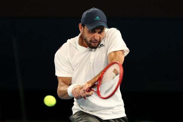 Aslan Karatsev is all concentration against Novak Djokovic in their semi-final clash.
