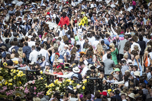 Jockey Mark Zahra returns to scale on Without A Fight in the midst of punters.