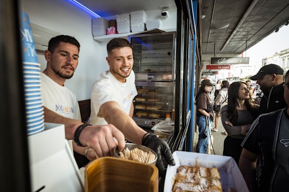 Kosta Kostidis (right), with Yianni Palazi, serves bougatsa pastries at his new shop, Bougatsaki, in Brunswick.