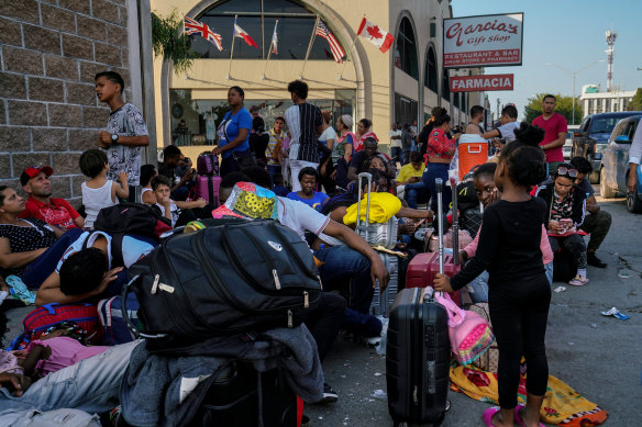 A group of mostly Venezuelans and Haitians with U.S. immigration appointments wait in Matamoros, Mexico.