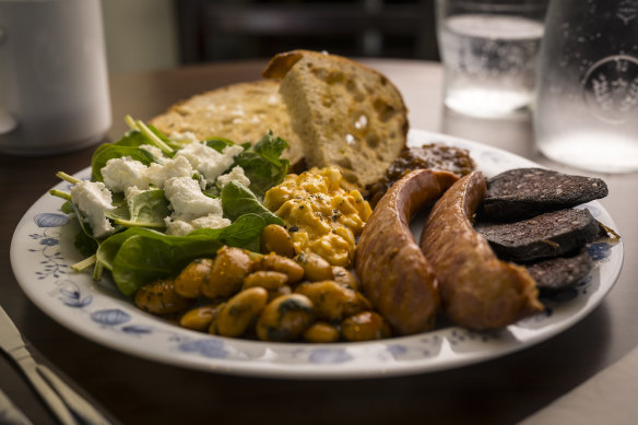 The breakfast plate with kransky, black pudding, Nordic egg spread, spiced butter beans, tomato relish, spinach, goat’s cheese and sourdough.