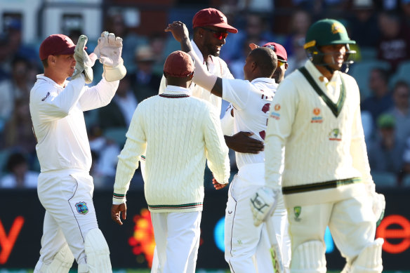 Jason Holder and the West Indies celebrate the wicket of Steve Smith.