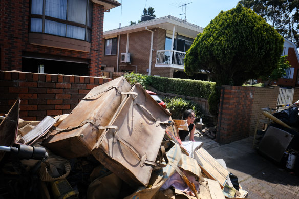 The leather suitcase sits on top of a pile of dumped possessions that didn’t survive.