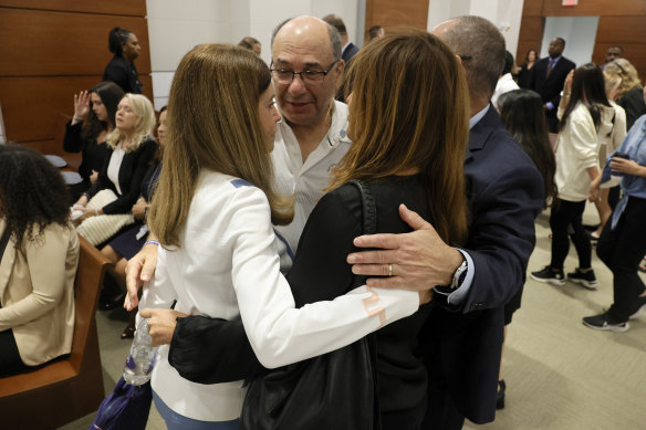 Linda Beigel Schulman, Michael Schulman, Patricia Padauy Oliver and Fred Guttenberg, families of the victims, embrace in the courtroom while waiting for an expected verdict.