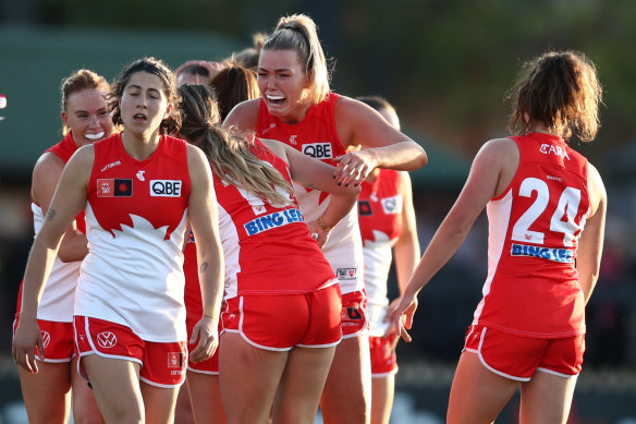 Ally Morphett leads the way as the Swans celebrate their first-ever AFLW win.