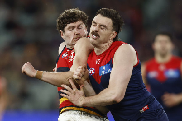 Demon Jake Lever delivers a bump on Adelaide’s Harry Schoenberg last season.