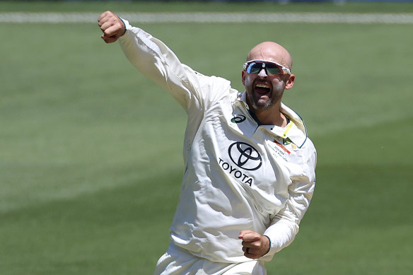 Nathan Lyon celebrates his first wicket on day two.