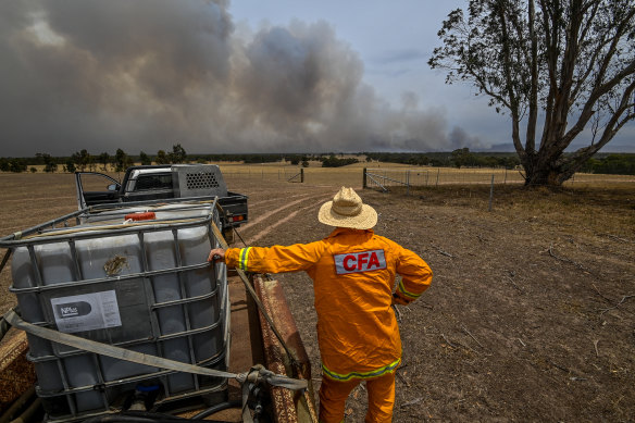 Farmer and CFA volunteer Tim Gubbins watches the fire next to his property near Moyston.