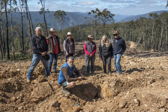 The group stands at the Jones coupe, the first of the 11 to be logged. (Left to right) Ray Anderson, Rhonda Treasure, Louise Crisp, Christa Treasure, Robyn Grant, Bruce Treasure and (front) Johh Hermans.