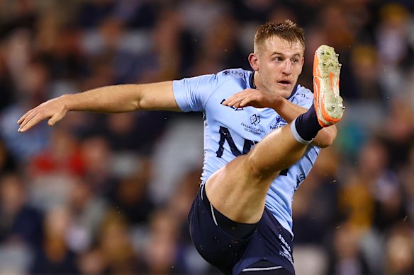Joey Walton of the Waratahs kicks ahead against the Brumbies