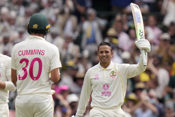 Usman Khawaja raises his bat after reaching 100 against England on Thursday.