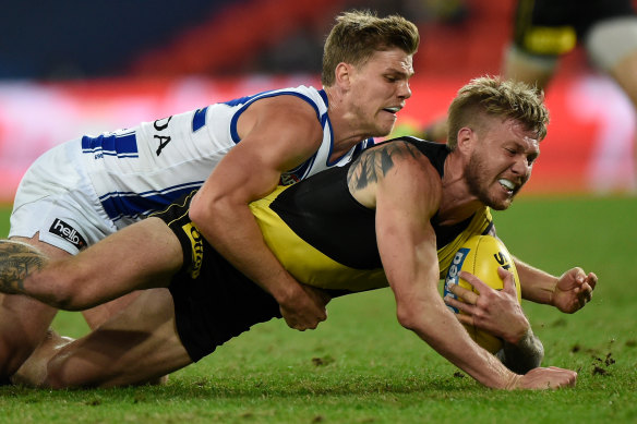 Former Roo Mason Wood tackles Nathan Broad during the 2020 season.