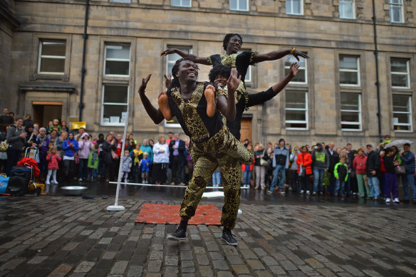 Street entertainers perform on the Royal Mile on the final day of the Edinburgh Festival Fringe in 2012.