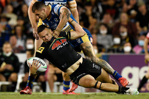 Panthers winger Brent Naden is manhandled by Eels hooker Ray Stone.