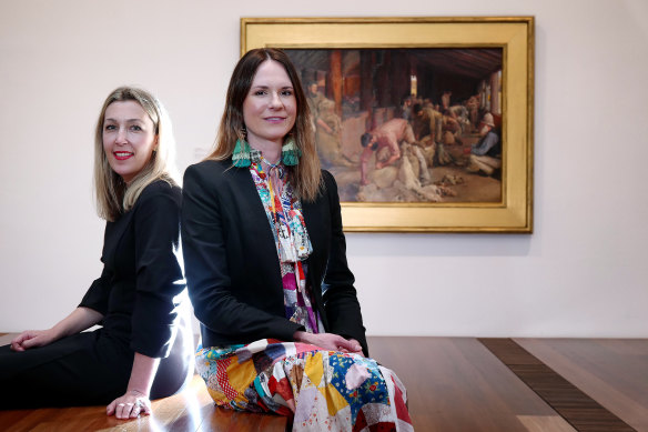 Gallery director Jessica Bridgfoot and curator Emma Busowky in front of Shearing the Rams, part of the exhibition Australiana: Designing a Nation.