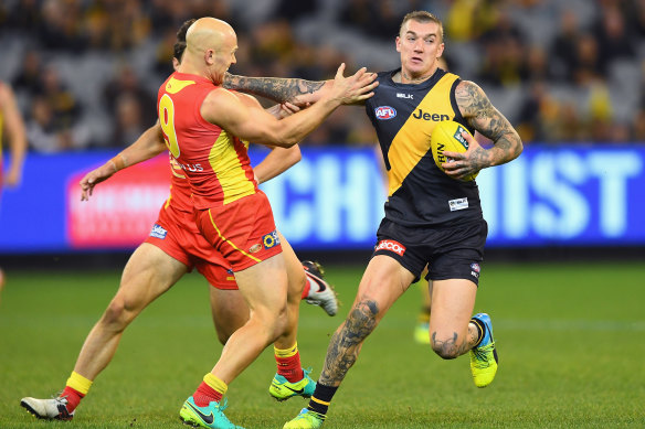 Richmond great Dustin Martin fends off Gold Coast and Geelong champion Gary Ablett.