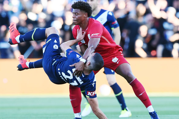 Adelaide’s Kusini Yengi battles with Victory’s Roderick Miranda.