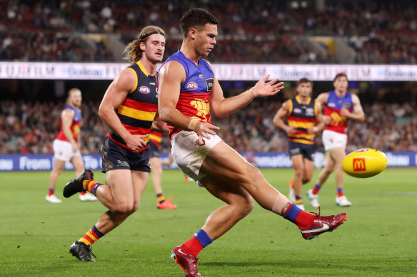 Cam Rayner gets a kick away for the Lions.