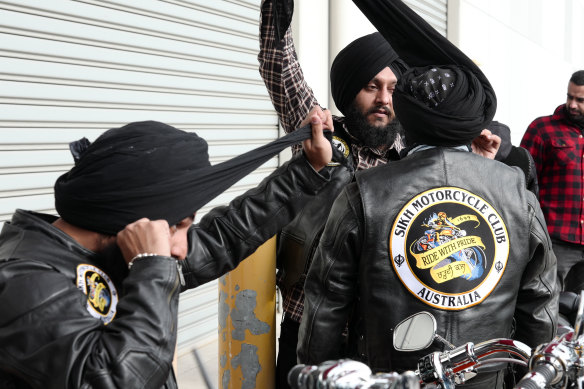 Club members untie their turbans before donning the helmets they must wear to ride.