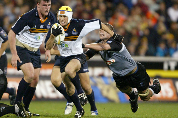 Matt Giteau surging ahead for the Brumbies in 2004, another title-winning season.