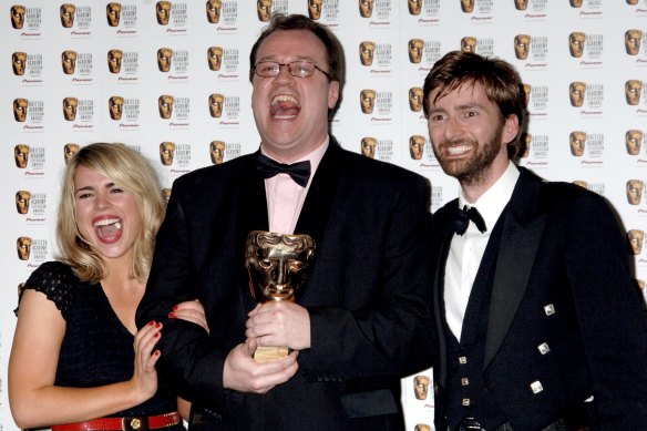 Russell T. Davies (centre) wins a British Academy Television Award in 2006 for Doctor Who alongside stars Billie Piper and David Tennant.