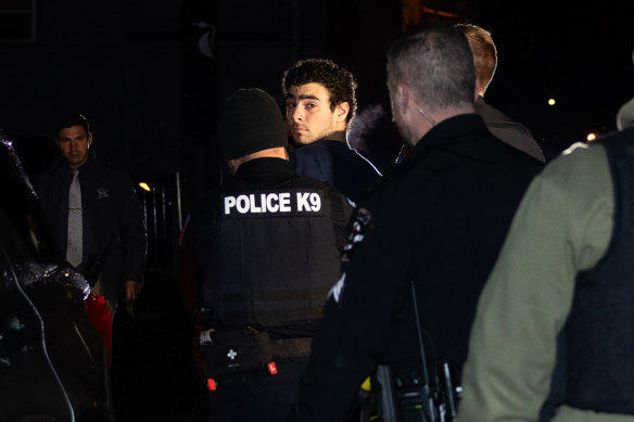 Luigi Mangione is escorted by police to his arraignment.