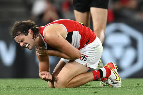 Hunter Clark winces in pain during the AAMI Community series match between St Kilda and Essendon last year.