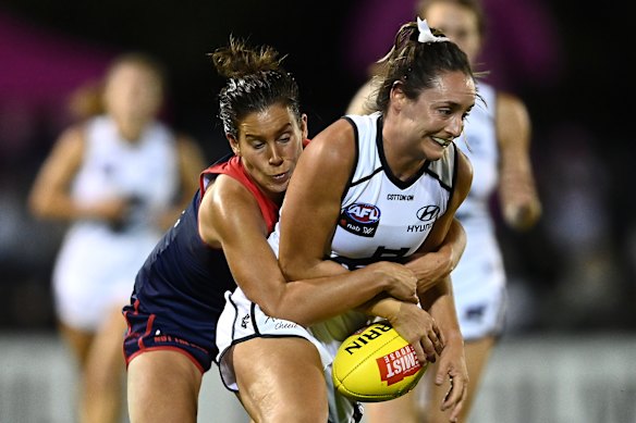 Libby Birch, left, tackles Nicola Stevens. 