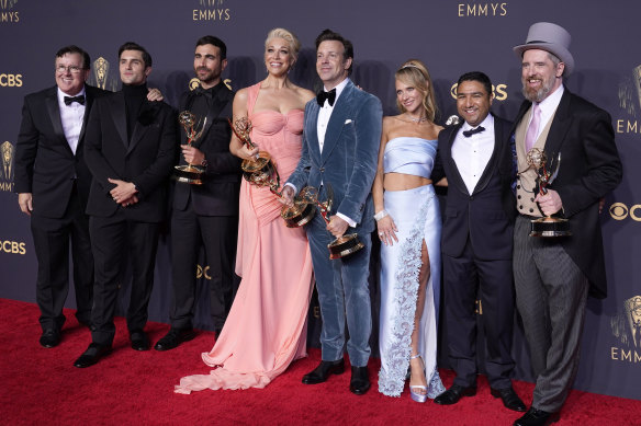 Brett Goldstein, Hannah Waddingham, Jason Sudeikis, Juno Temple and the cast and crew from Ted Lasso pose with their Emmy awards.