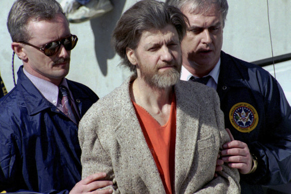 Theodore “Ted” Kaczynski is flanked by federal agents as he is led to a car from the federal courthouse in Helena, Montana, on April 4, 1996. 