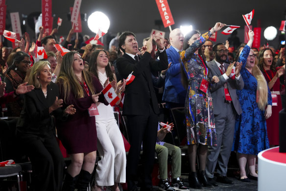 Outgoing Prime Minister Justin Trudeau cheers as Mark Carney delivers his victory speech after winning the Liberal Party leadership.