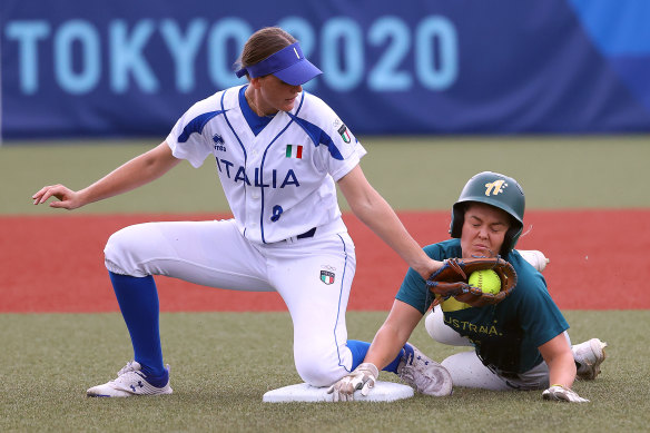 Taylah Tsitsikronis cops a tag to the face as she slides safely into second base.