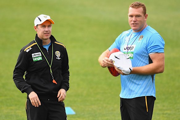 Pies coach Craig McRae, and assistant Justin Leppitsch.