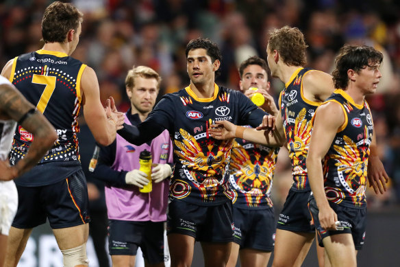 Shane McAdam, centre, celebrates a goal. 