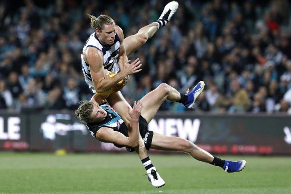Xavier Duursma bears the brunt in a collision with Geelong's Mark Blicavs.