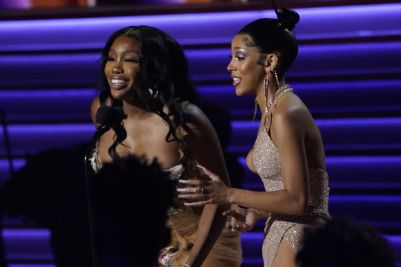 SZA, left, and Doja Cat accept the award for best pop duo/group performance for Kiss Me More at the Grammys. 