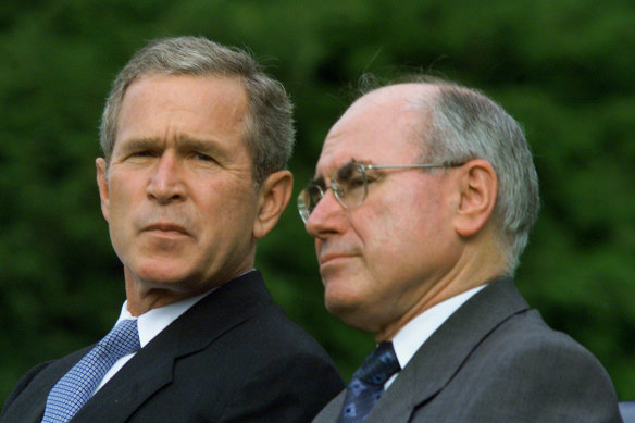 John Howard (right) alongside US president George W. Bush, took Australia to war in Iraq in 2003.