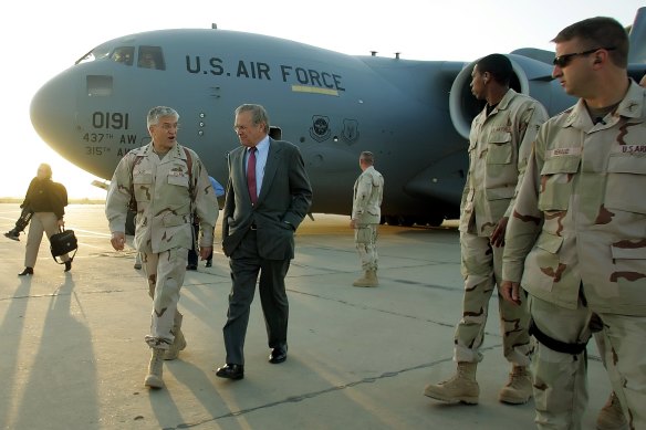 Then US secretary of defence Donald Rumsfeld, centre, arrives unannounced at Baghdad International Airport in Baghdad, Iraq, in April 2006.
