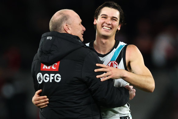 Port captain Connor Rozee (right) embraces coach Ken Hinkley, who is much admired by his players. 