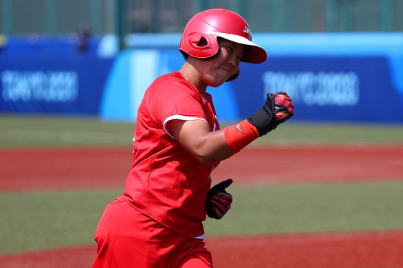 Minori Naito celebrates her two-run home run as she rounds the bases.