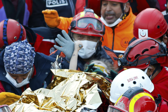 Elif Perincek clings to the thumb of a rescue worker after being pulled from the earthquake rubble in Izmir, Turkey.