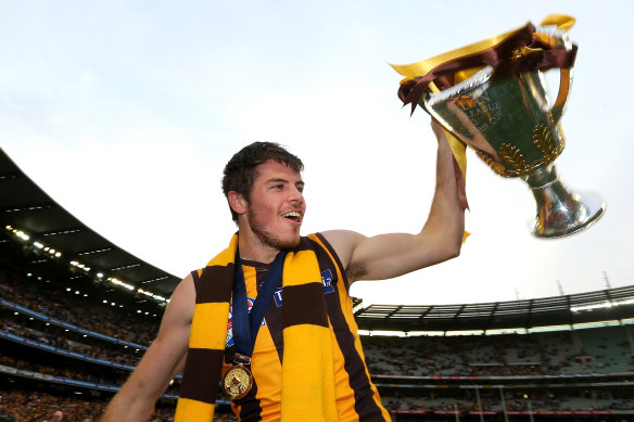 Smith with the 2013 premiership cup during his time as a Hawk.